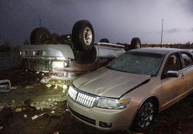 Cars that were damaged by a tornado in parking lot at Canadian Valley Technical Center on State Highway 66, west of Banner Road, Friday May 31, 2013 in El Reno, Okla. (AP Photo/The Oklahoman, Jim Beckel) 