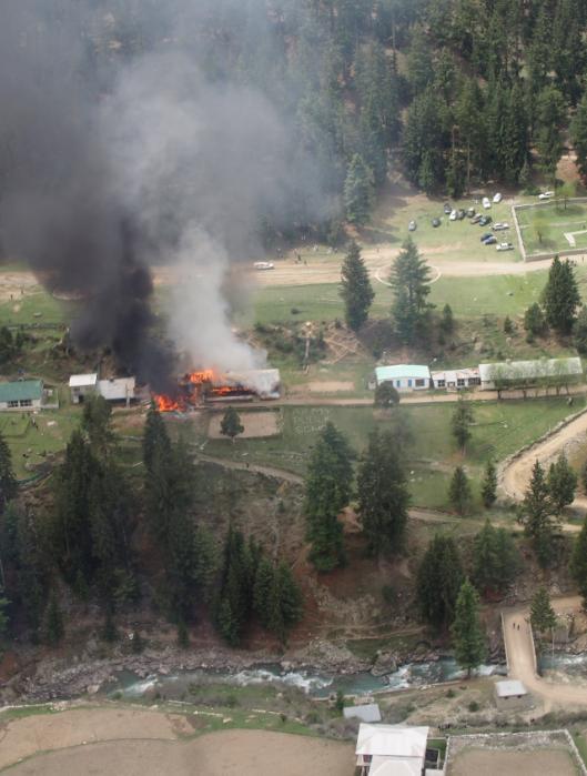 Smoke rises from a fire at the site of a helicopter crash that killed the ambassadors to Pakistan from the Philippines and Norway and the wives of the ambassadors from Malaysia and Indonesia in Gilgit, Pakistan, Friday, May 8, 2015. The diplomats and diplomatic sposes were among seven people killed Friday when a Pakistani army helicopter carrying foreign dignitaries crash landed in the country's north. (Maha Mussadaq/The Express Tribune via AP)